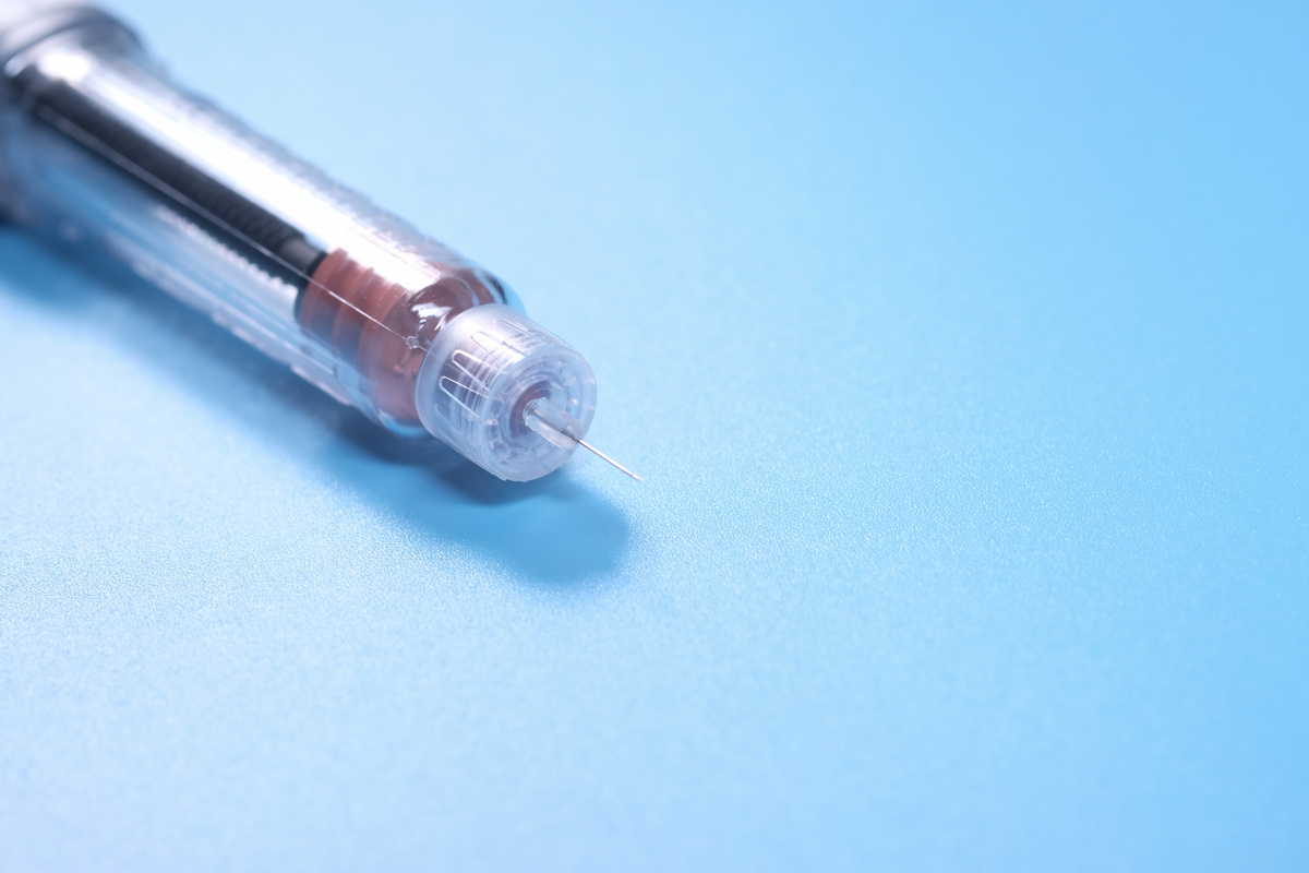 Insulin Pens with Copy Space on Blue Background